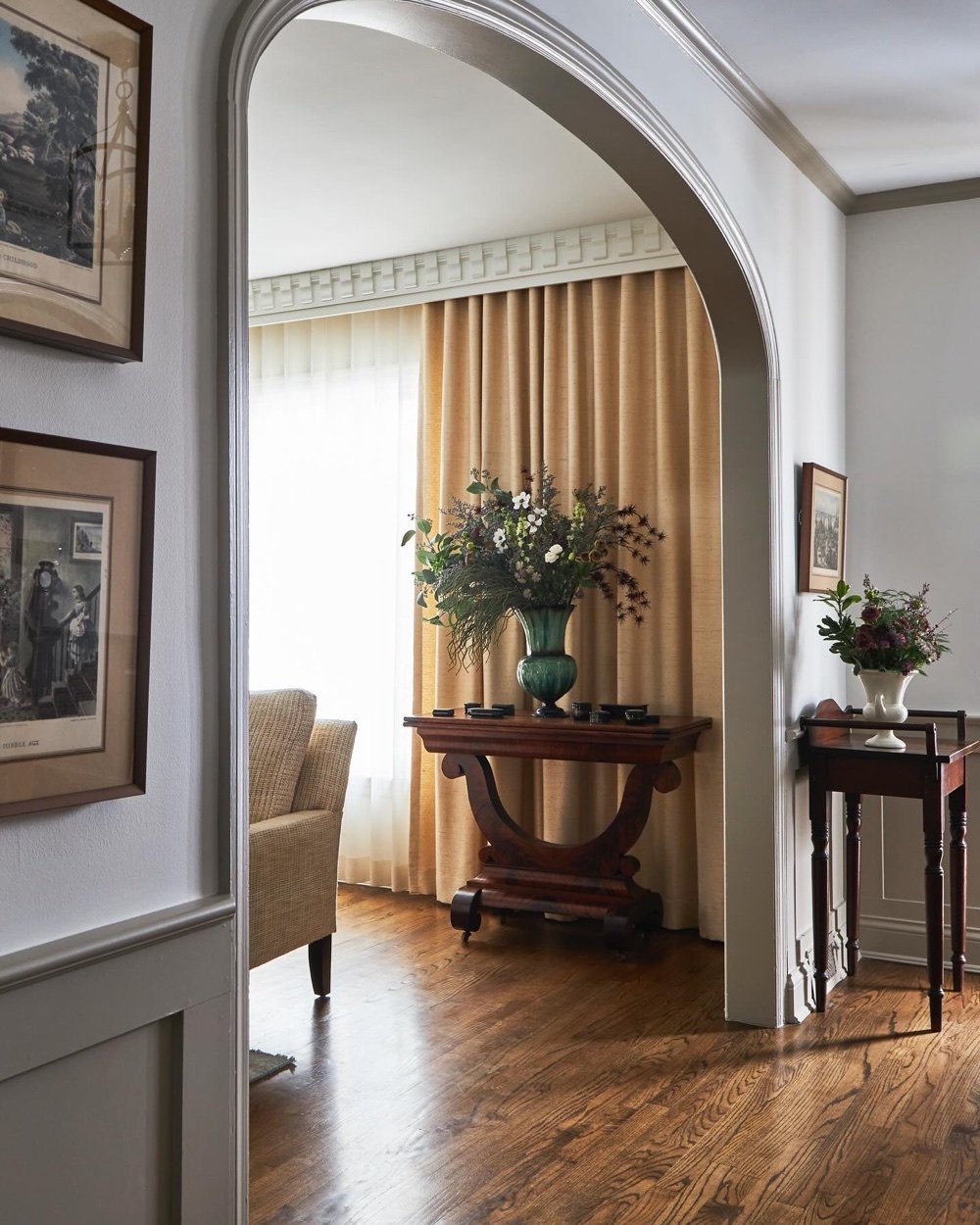 Foyer/hallway through arch with console and drapery, luxury renovation and interior design by Martire Custom Homes