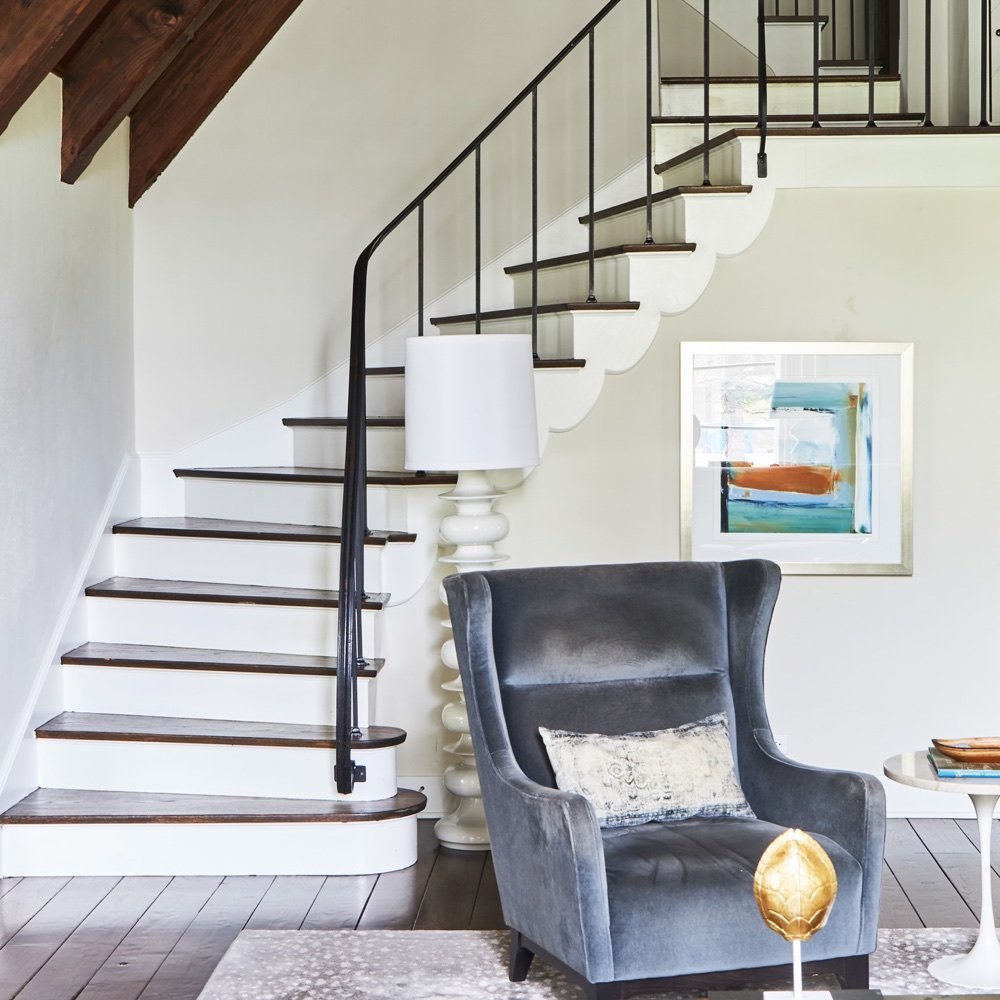Restored staircase with foyer seating, luxury renovation and interior design by Martire Custom Homes