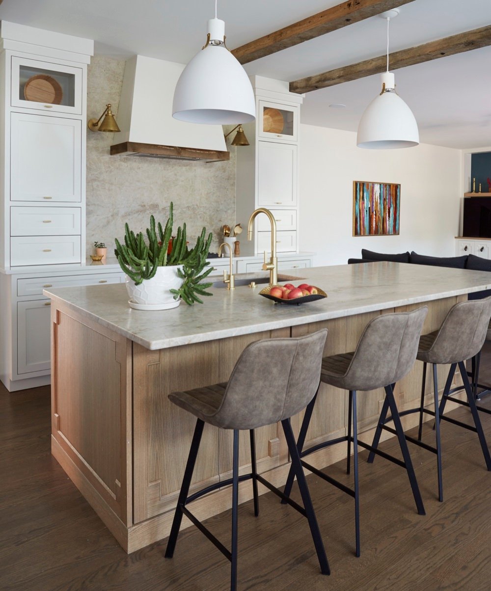 Kitchen with white oak island, cinnamon-veined quartzite counters, matte white pendants, reclaimed ceiling beams and brass faucets, by Martire Custom Homes